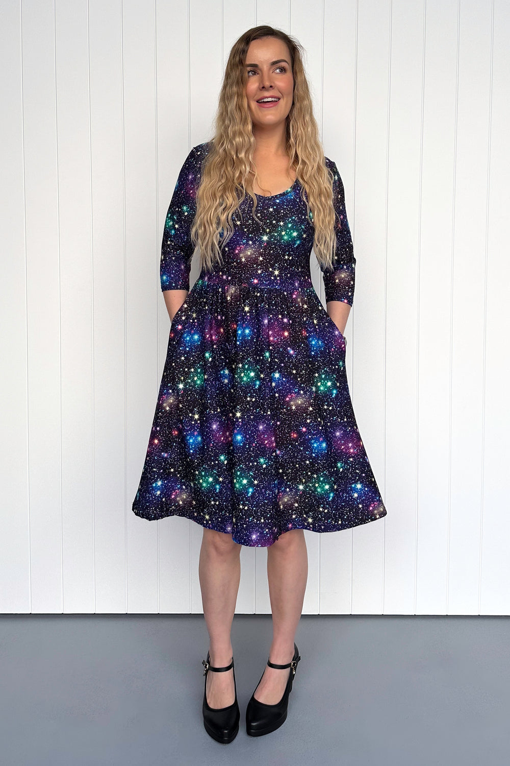 Woman wearing a star-patterned dress against a white background