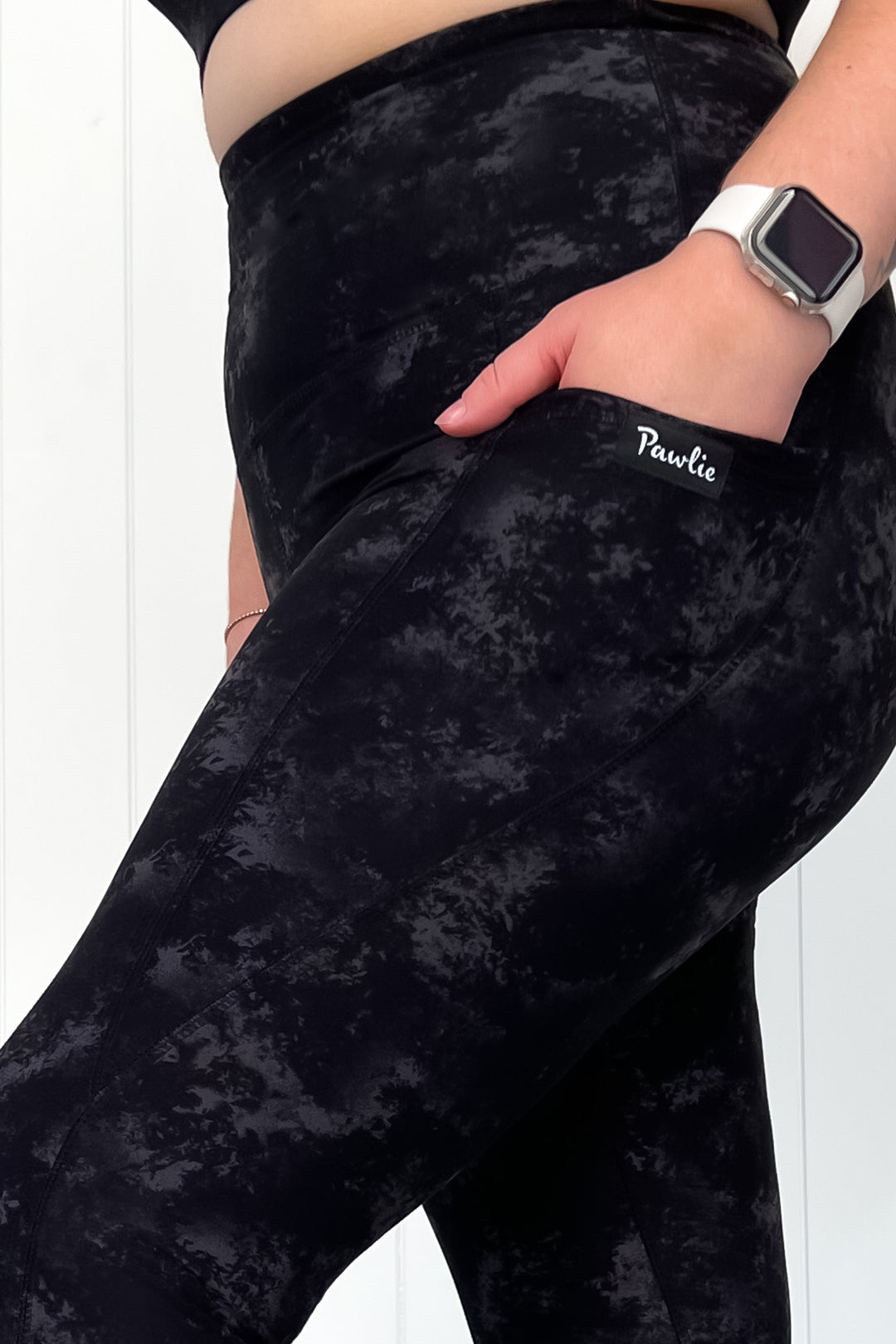 Black patterned leggings with a visible brand logo on a white background